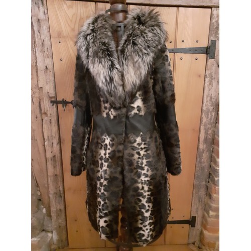 160 - Marccain- An animal print ladies coat having a wolf fur collar and zig-zag black leather waistband a... 