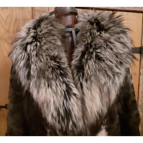 160 - Marccain- An animal print ladies coat having a wolf fur collar and zig-zag black leather waistband a... 