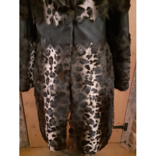 160 - Marccain- An animal print ladies coat having a wolf fur collar and zig-zag black leather waistband a... 