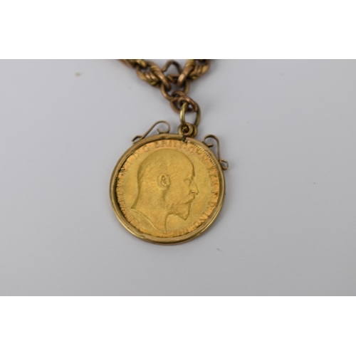 13 - A 9ct gold early 20th century watch chain having T bar and dog clip, along with a mounted 1909 half ... 