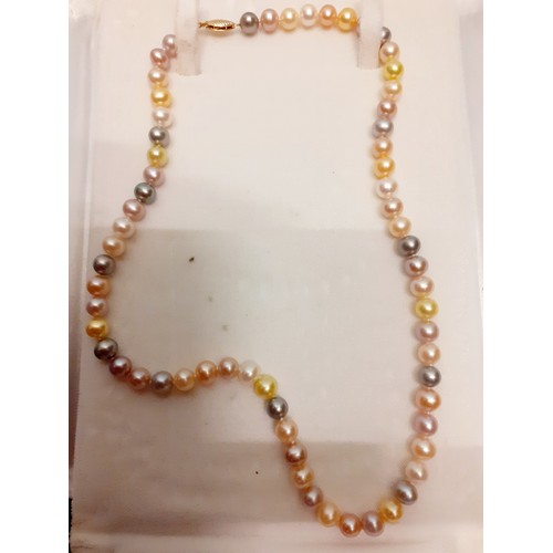 144 - A string of Uyeda coloured simulated pearls having a 14ct gold clasp stamped 14k in a branded fabric... 