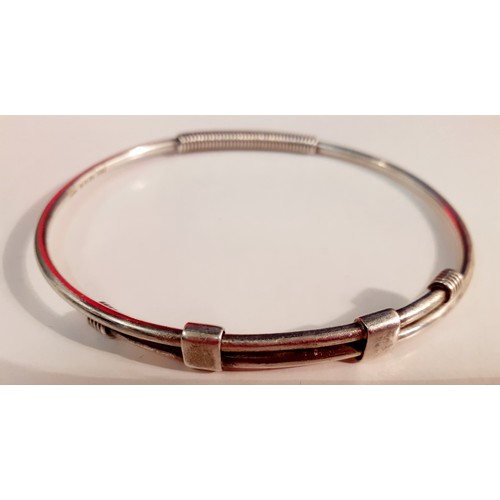 170 - Gucci- A silver adjustable bangle stamped with the designer's name, 17.59g. Location:CAB3