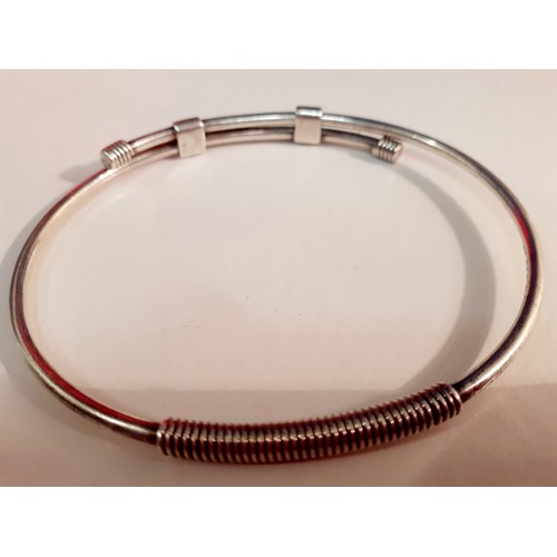 170 - Gucci- A silver adjustable bangle stamped with the designer's name, 17.59g. Location:CAB3