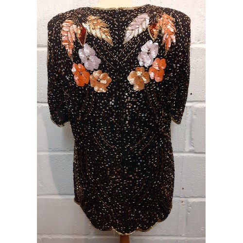 174 - Frank Usher-A 1980's bejewelled evening top with scalloped hem and sleeves, having a black ground wi... 