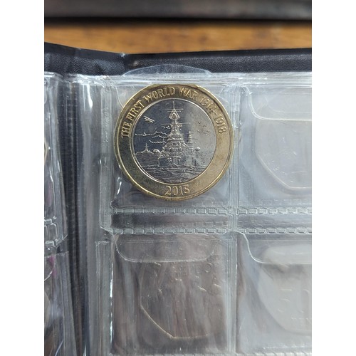 81 - An album of 20, 50p and one £2 coin to include a replica/re-strike 2009 Kew gardens 50p, London 2012... 