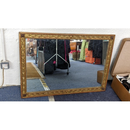 330 - An early 20th century mirror having a gilt highlighted and floral moulded border, 69cm h x 99.5cm w
... 