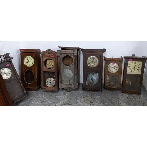 409 - A selection of wall clocks to include four American wall clocks, some missing parts, depicting scene... 