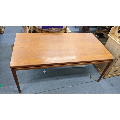 412 - A retro teak extending dining table with two extra leaves and on turned tapering legs, 72cm h x 165c... 