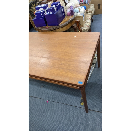 412 - A retro teak extending dining table with two extra leaves and on turned tapering legs, 72cm h x 165c... 