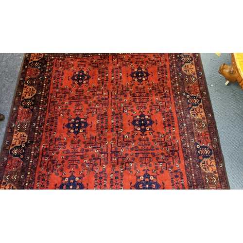 415 - A Persian hand woven rug having a floral design on a red ground and multi-guard borders, 162cm x 189... 