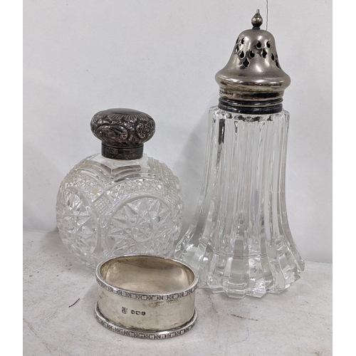 444 - An early 20th century silver napkin ring together with a silver topped dressing table jar and a silv... 