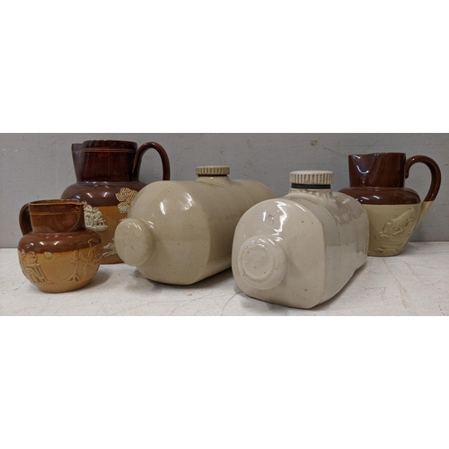 473 - Three Doulton Lambeth jugs of various sizes and a pair on stone bed warmers
Location:A3F / A4F