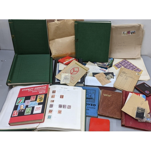 497 - A world postage stamp collection to include 19th century and later examples contained in albums, on ... 