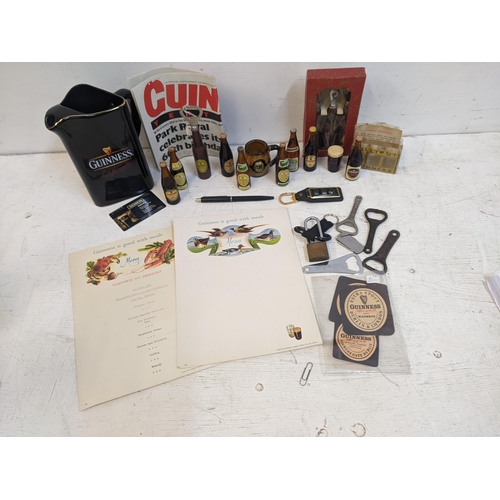 319A - Guinness advertising collectables to include miniature beer bottles, a retirement menu, bottle opene... 