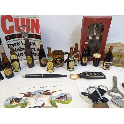 319A - Guinness advertising collectables to include miniature beer bottles, a retirement menu, bottle opene... 