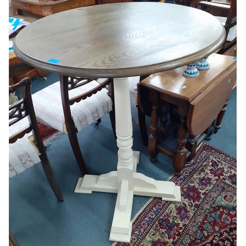 462 - A late 20th Century bistro table having a circular wooden top above a cream painted pedestal. Locati... 