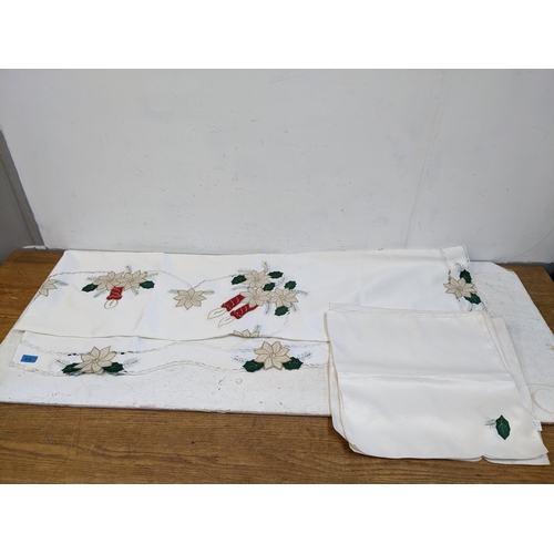 519 - A polyester tablecloth and eleven matching napkins having a Christmas floral design Location:G