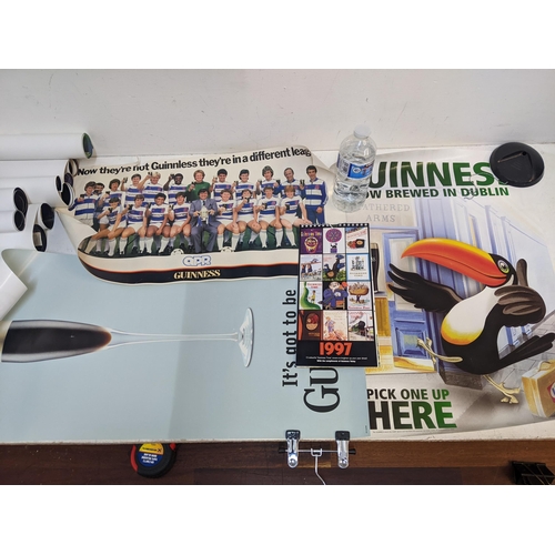 302 - Guinness related collectables to include printed posters, advertising signs and calendars Location: ... 