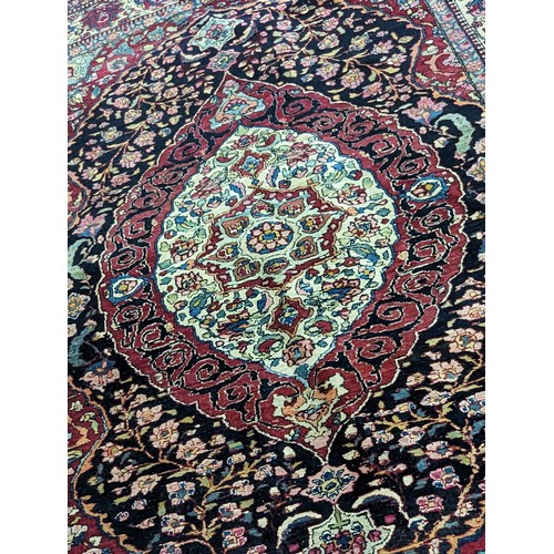 430 - A Persian hand woven red ground rug having central motif, floral multi-guard border, 144cm x 200cm
L... 