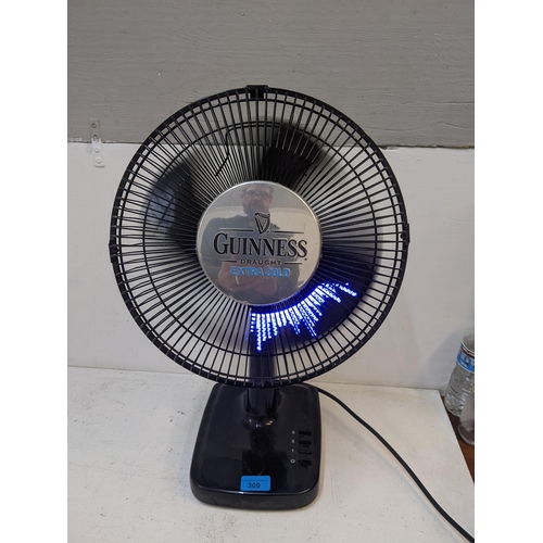 309 - A Guinness advertising table top fan with illuminated blades spelling 'Just that little bit colder, ... 