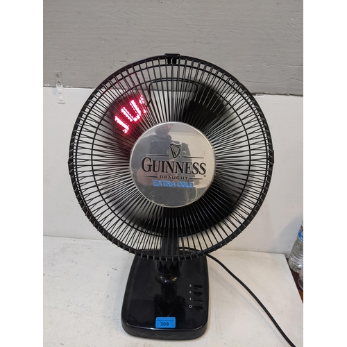 309 - A Guinness advertising table top fan with illuminated blades spelling 'Just that little bit colder, ... 