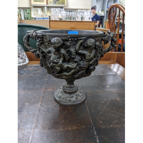 445 - A 19th century bronze twin handled bowl in the Classical style decorated with Grecian figures, 23cm ... 