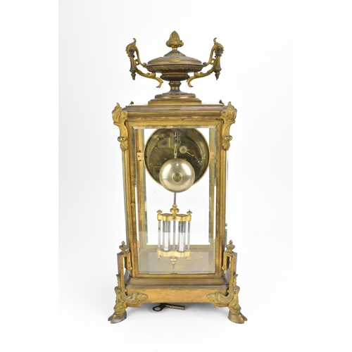 117 - A French 19th century ormolu mounted four glass mantle clock, with central enamel dial with Roman nu... 