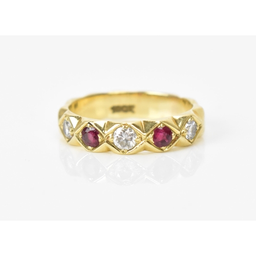 182 - A yellow gold, ruby and diamond ring, set with three brilliant cut diamonds and two rubies, on a fac... 