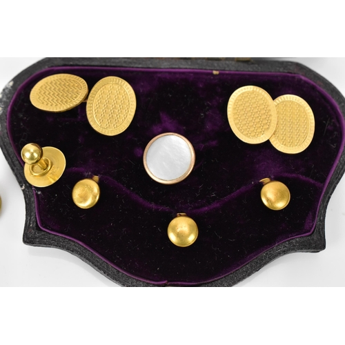 187 - A pair of early 20th century 9ct yellow gold cuff links, together with a boxed set of 18ct dress stu... 