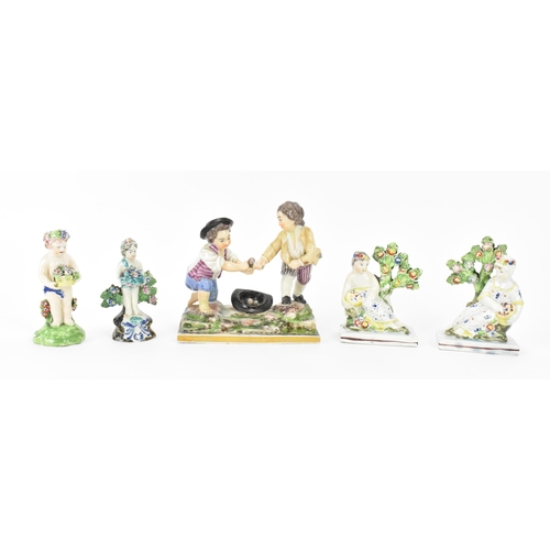 198 - A small group of early Staffordshire pottery, comprising a pair of pearlware reclining figures holdi... 