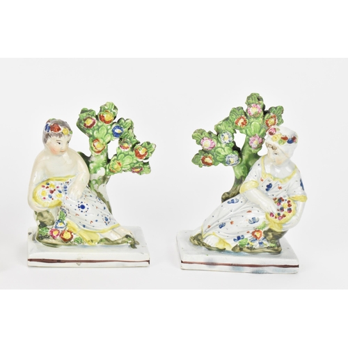 198 - A small group of early Staffordshire pottery, comprising a pair of pearlware reclining figures holdi... 