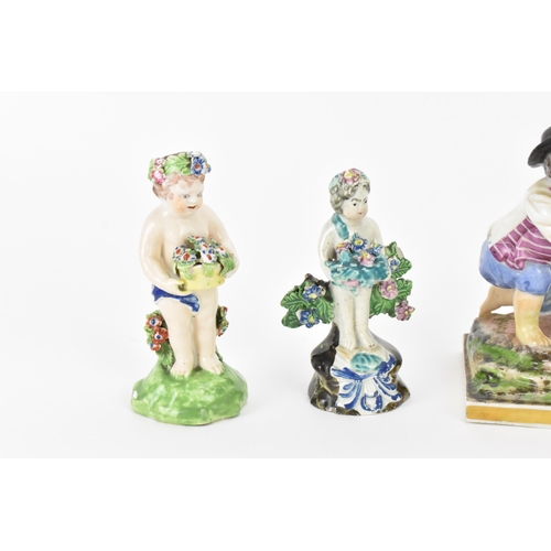 198 - A small group of early Staffordshire pottery, comprising a pair of pearlware reclining figures holdi... 