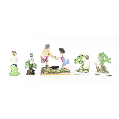 198 - A small group of early Staffordshire pottery, comprising a pair of pearlware reclining figures holdi... 