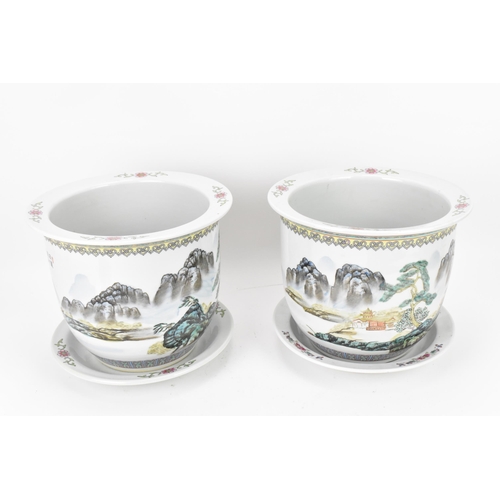 211 - A pair of Chinese 20th century porcelain planters, each depicting enamel mountainous landscapes with... 