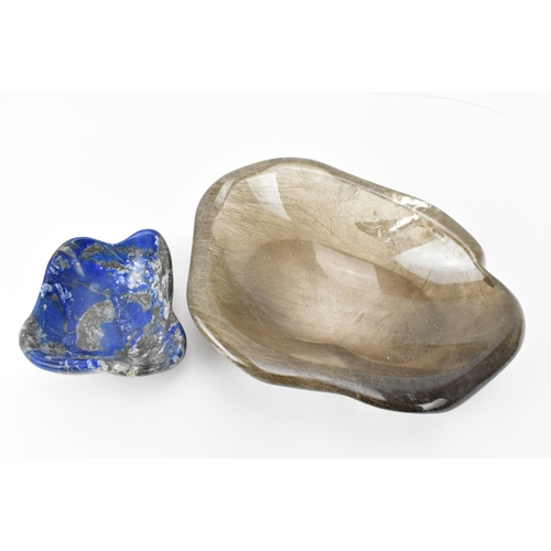 213 - A rutilated quartz freeform bowl, together with a smaller freeform polished lapis lazuli bowl, the q... 