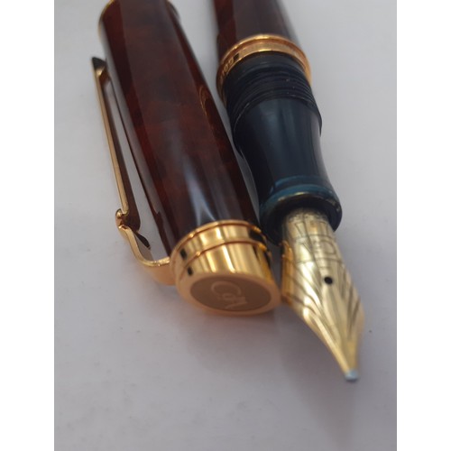 8 - A 1993 Caran d'Ache fountain pen having a brown burr walnut effect body with 18ct gold plated collar... 