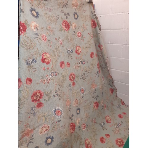 92 - A large American style bed cover having a green ground with swirls of flora and leaves in reds and b... 