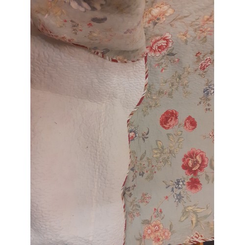 92 - A large American style bed cover having a green ground with swirls of flora and leaves in reds and b... 