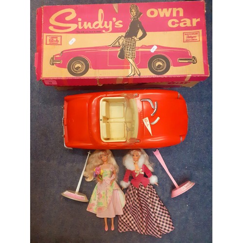38 - A boxed vintage red Sindy car A/F in original box and 2 late 20th Century Barbie dolls on stands com... 