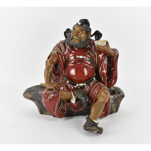 144 - A large 20th century Chinese shiwan glazed pottery model of Zhong Kui by Liu Zemian, in a seated pos... 