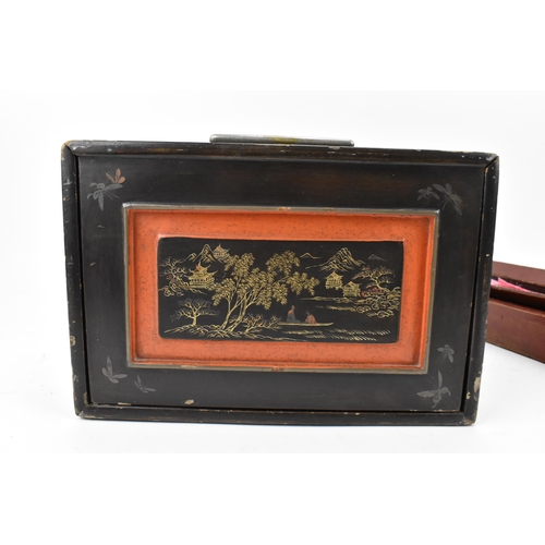 149 - A Mah-Jong set within a black, and red lacquer box decorated with gilt chinoiserie, the slide front ... 