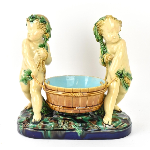 181 - A late 19th century Minton majolica centrepiece, circa 1858, modelled as two dyonisian cherubs carry... 