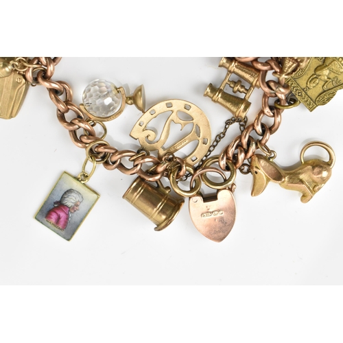 189 - A 9ct rose gold charm bracelet, with a Victorian 1900 half sovereign coin, and various hanging charm... 