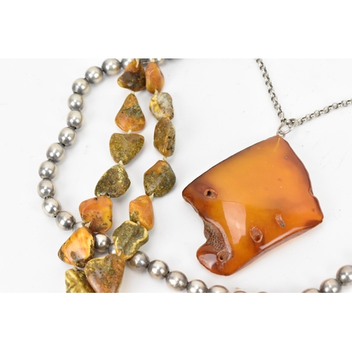 190 - A collection of raw and polished baltic amber jewellery, comprising large pendants, bracelets and ne... 