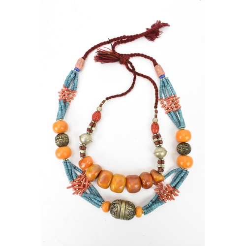 191 - Two Moroccan Berber style pressed amber, white metal, and coral necklaces, one with turquoise beads,... 