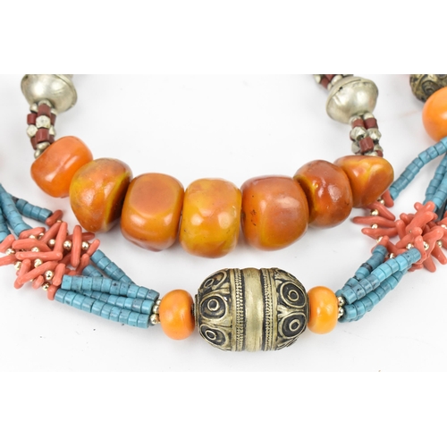 191 - Two Moroccan Berber style pressed amber, white metal, and coral necklaces, one with turquoise beads,... 