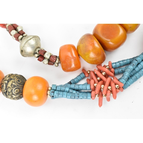 191 - Two Moroccan Berber style pressed amber, white metal, and coral necklaces, one with turquoise beads,... 