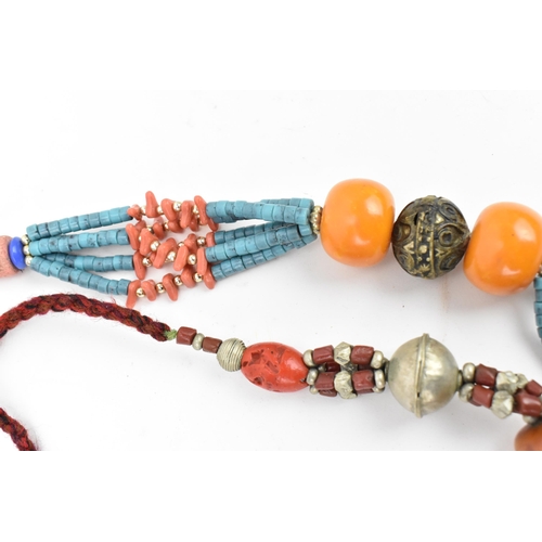 191 - Two Moroccan Berber style pressed amber, white metal, and coral necklaces, one with turquoise beads,... 