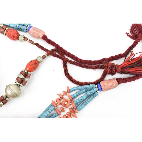 191 - Two Moroccan Berber style pressed amber, white metal, and coral necklaces, one with turquoise beads,... 