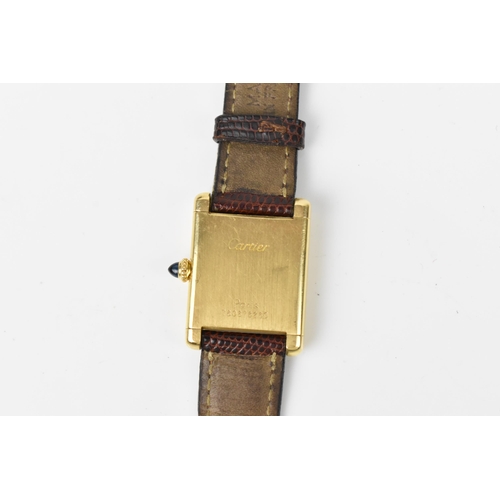 26 - A Cartier Tank, manual wind, ladies, 18ct gold wristwatch, having a white dial with Roman numerals, ... 